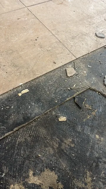 Black bitumen mastic floor removal in a SW12 flat